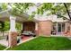 Serene backyard featuring a covered patio with comfortable seating and a lush green lawn at 8122 E 6Th Pl, Denver, CO 80230