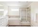 Bright bathroom with a soaking tub, glass-enclosed shower, and a vanity with storage at 8122 E 6Th Pl, Denver, CO 80230