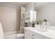 A charming bathroom with a shower-tub combo, updated vanity, and decorative accents at 8122 E 6Th Pl, Denver, CO 80230