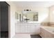 Elegant bathroom with double vanity, soaking tub, and walk-in shower for a spa-like experience at 8122 E 6Th Pl, Denver, CO 80230