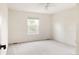 Bright bedroom featuring neutral walls, carpet, and a window offering green tree views at 8122 E 6Th Pl, Denver, CO 80230