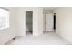 A bright bedroom with a large window and closet space, freshly painted and carpeted at 8122 E 6Th Pl, Denver, CO 80230