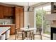 Cozy dining area with modern light fixture, table, and views of the backyard through a bright sliding glass door at 8122 E 6Th Pl, Denver, CO 80230