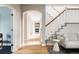 Open hallway with hardwood floors, staircase, and neutral walls creating a seamless flow throughout the home at 8122 E 6Th Pl, Denver, CO 80230