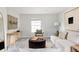 Cozy living room with a plush sofa, ottoman, and stylish decor for relaxing and entertaining at 8122 E 6Th Pl, Denver, CO 80230