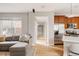 Spacious open-concept living area with a kitchen, couch, and hallway at 8122 E 6Th Pl, Denver, CO 80230