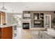 Open concept living area with fireplace, built-in shelving, and seamless flow from kitchen to living space at 8122 E 6Th Pl, Denver, CO 80230