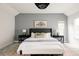 Comfortable main bedroom featuring a king bed, modern lamps, and neutral decor at 8122 E 6Th Pl, Denver, CO 80230