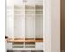 Spacious mud room with white shelving, coat hooks, and a wood bench for organization at 8122 E 6Th Pl, Denver, CO 80230
