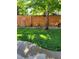 Landscaped backyard with wooden fence and yard art at 2400 S Halifax Way, Aurora, CO 80013