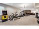 Spacious basement with a home gym and arcade game at 2400 S Halifax Way, Aurora, CO 80013