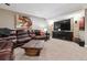 Finished basement with leather sectional sofa and large TV at 2400 S Halifax Way, Aurora, CO 80013