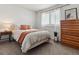 Comfortable bedroom with a dresser and window seating at 2400 S Halifax Way, Aurora, CO 80013