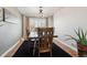 Dining room with hardwood floors, a wooden table, and large windows at 2400 S Halifax Way, Aurora, CO 80013