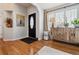 Entryway with hardwood floors, a black door, and a wooden cabinet at 2400 S Halifax Way, Aurora, CO 80013