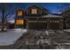 Two-story house with a three-car garage and snow-covered front yard at 2400 S Halifax Way, Aurora, CO 80013