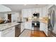 Kitchen with white cabinets, granite countertops, and stainless steel appliances at 2400 S Halifax Way, Aurora, CO 80013