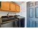 Bright laundry room with modern washer and dryer, ample cabinets and counter space at 2400 S Halifax Way, Aurora, CO 80013