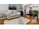 Living room with hardwood floors, a sofa, and a view to the dining room at 2400 S Halifax Way, Aurora, CO 80013