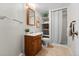 Cozy bathroom features a single sink vanity, shower, and tiled floors at 6664 S Webster St, Littleton, CO 80123