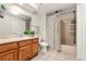 Bathroom featuring a tiled shower, and wood vanity at 6664 S Webster St, Littleton, CO 80123