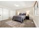 Bedroom with neutral colors, closet doors and plush carpet at 6664 S Webster St, Littleton, CO 80123