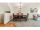 Dining room with hardwood floors, large windows, and a modern chandelier at 6664 S Webster St, Littleton, CO 80123