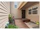 Front porch entrance with wooden deck and black wrought iron security door at 6664 S Webster St, Littleton, CO 80123