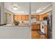 Bright kitchen featuring wood cabinets, stainless steel appliances, and an open layout at 6664 S Webster St, Littleton, CO 80123