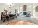 Living room with high ceilings, brick fireplace, large windows and a dining table at 6664 S Webster St, Littleton, CO 80123