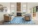 Living room with high ceilings, brick fireplace, large windows and comfortable seating at 6664 S Webster St, Littleton, CO 80123