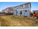 This backyard features a grass yard, a basketball hoop and a wooden fence at 5556 Lewiston Ct, Denver, CO 80239
