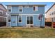 This backyard has a basketball hoop, a grass yard, and sliding glass doors at 5556 Lewiston Ct, Denver, CO 80239