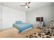 This bedroom includes a ceiling fan, bed, flat screen tv and decorative furniture at 5556 Lewiston Ct, Denver, CO 80239