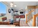 Open dining area with glass table, wicker chairs, and staircase leading to the upper level at 5556 Lewiston Ct, Denver, CO 80239