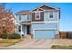 Beautiful two-story home featuring blue siding, a two-car garage, and a well-kept front yard at 5556 Lewiston Ct, Denver, CO 80239