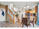 Open concept kitchen with stainless appliances, tile floor, and an adjacent stairway at 5556 Lewiston Ct, Denver, CO 80239