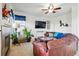 Comfortable living room with a large leather sofa, fireplace, and ceiling fan at 5556 Lewiston Ct, Denver, CO 80239