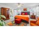 Bright main bedroom featuring a large bed, colorful art, a ceiling fan, carpet, and ensuite bath at 5556 Lewiston Ct, Denver, CO 80239