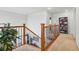 Bright stairway with carpeted steps, wood and iron railing, and views of other rooms at 5556 Lewiston Ct, Denver, CO 80239