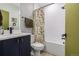 Stylish bathroom features a shower and tub combo, white tile, designer vanity, and modern fixtures at 4925 W 10Th Ave # 111, Denver, CO 80204