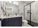 Modern bathroom with double vanity, stylish wall tile, and glass enclosed shower at 4925 W 10Th Ave # 111, Denver, CO 80204