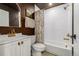 Bathroom features a white vanity, subway tile, and a shower-tub combination at 4925 W 10Th Ave # 111, Denver, CO 80204