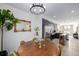 Open-concept dining room featuring modern chandelier and dark kitchen cabinets at 4925 W 10Th Ave # 111, Denver, CO 80204