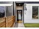 Stylish townhouse entrance with a black door, modern house number, and a welcoming wreath at 4925 W 10Th Ave # 111, Denver, CO 80204