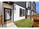 Contemporary townhouse with a black door, modern details, and a small, well-kept front yard at 4925 W 10Th Ave # 111, Denver, CO 80204
