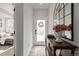 Bright entryway with a console table, decorative mirror, and a view into the living area at 4925 W 10Th Ave # 111, Denver, CO 80204