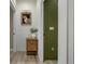 Hallway with a painted green accent wall and interior doors at 4925 W 10Th Ave # 111, Denver, CO 80204