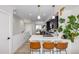 Modern kitchen with white countertops, sleek black cabinets, pendant lights, and a dining area at 4925 W 10Th Ave # 111, Denver, CO 80204