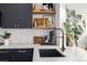 Modern kitchen featuring black cabinetry, white countertops, and a stylish sink with black faucet at 4925 W 10Th Ave # 111, Denver, CO 80204